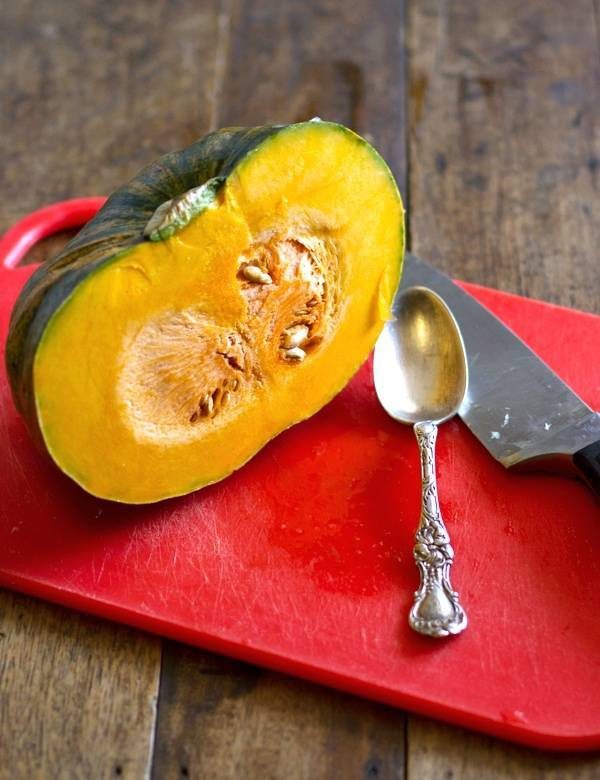 Kabocha squash on a red cutting board.