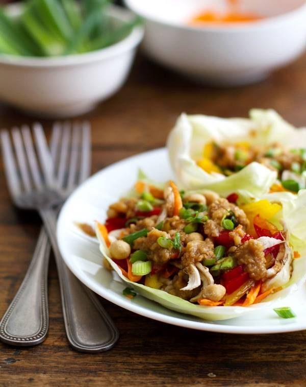 Thai chicken lettuce wraps on a plate with forks.