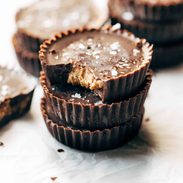 Stack of three almond butter cups.