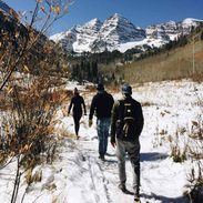 Friends walking in the snowy mountains.