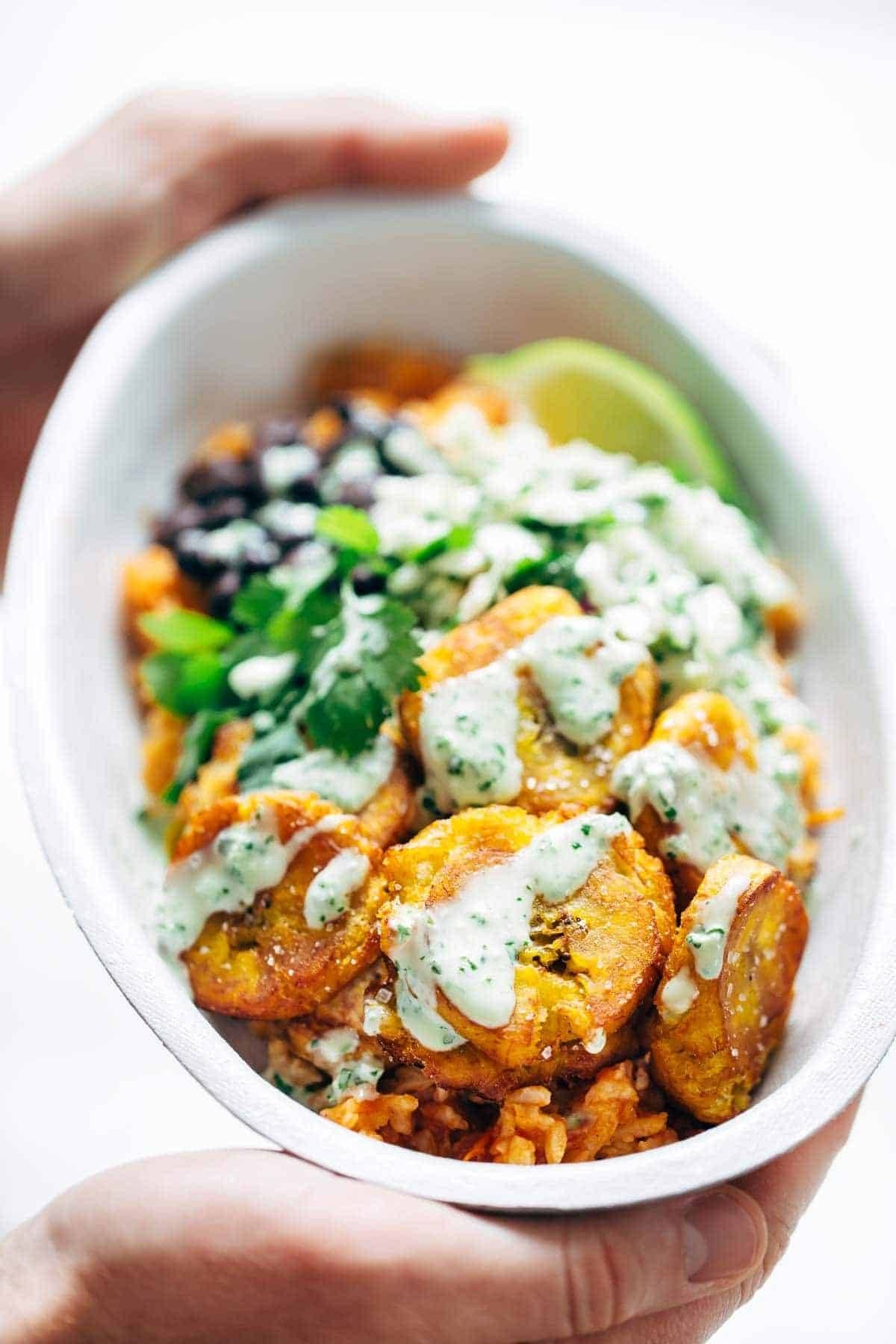 Spicy Brazilian Burrito Bowls recipe featuring seasoned rice and beans, garlic cilantro lime slaw, and crispy fried plantains. So good // almost vegan. | pinchofyum.com Spicy Brazilian Burrito Bowls recipe featuring seasoned rice and beans, garlic cilantro lime slaw, and crispy fried plantains. So good // almost vegan. | pinchofyum.com