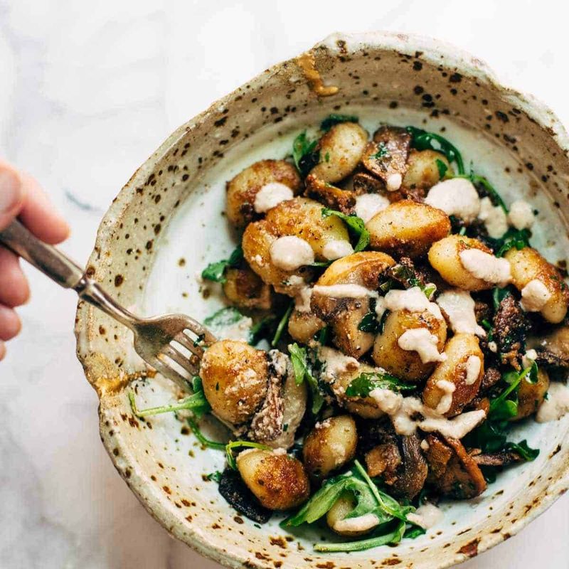 A picture of Mushroom Gnocchi with Arugula and Walnut Pesto