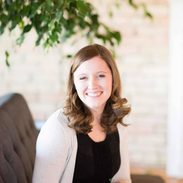 Jenna sitting on a couch in the studio.
