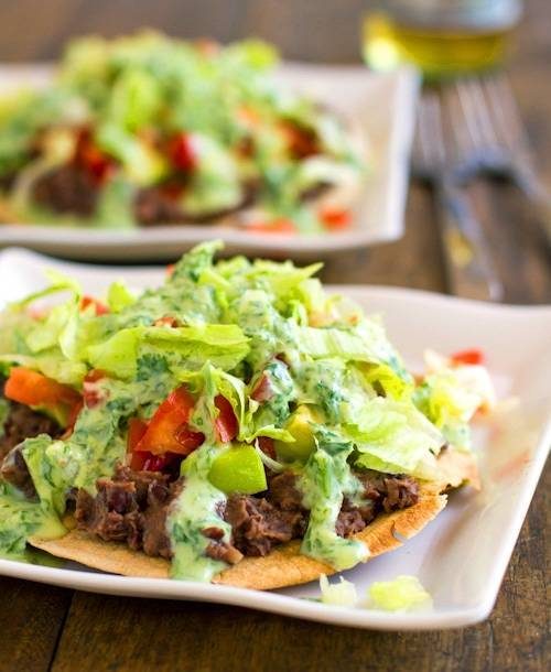 Black bean tostadas drizzled with a homemade healthy cilantro sauce.