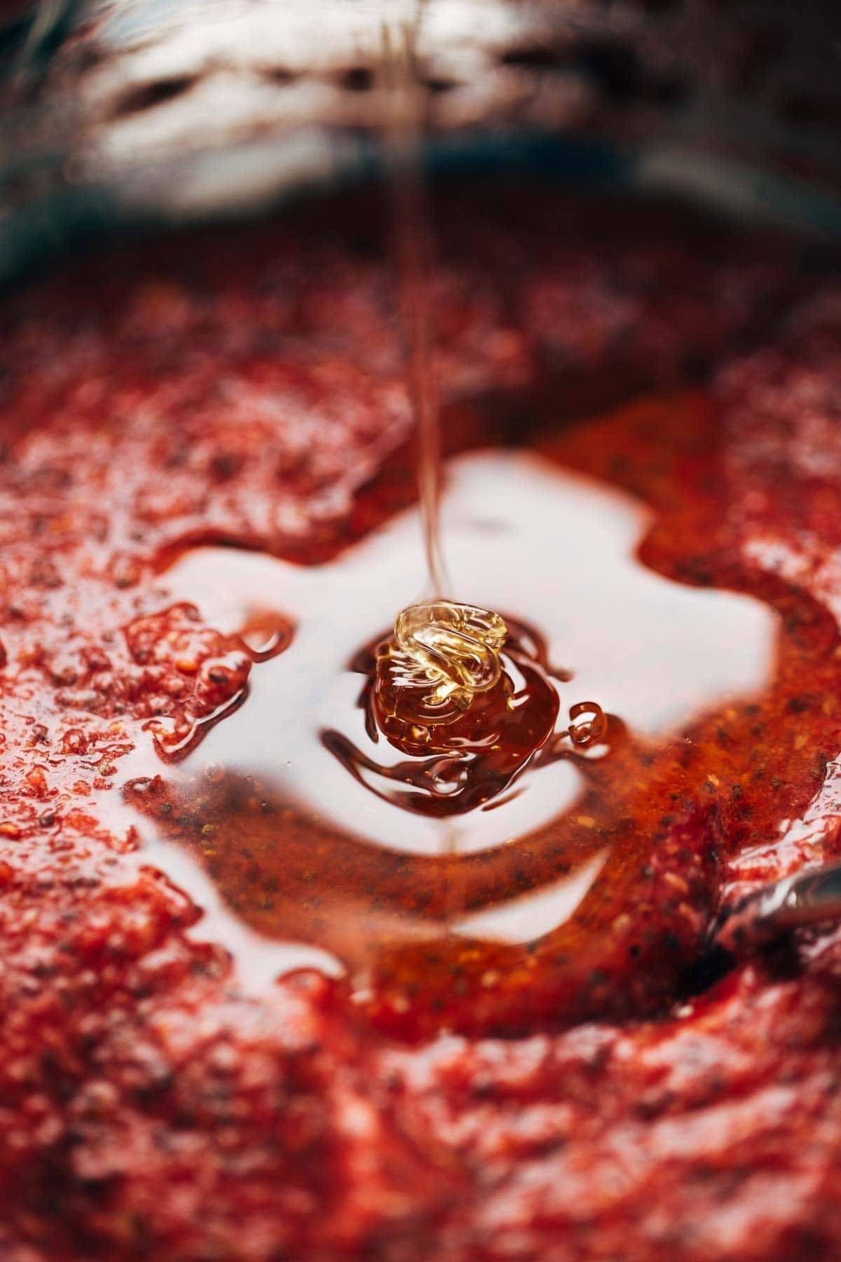 Honey drizzle on a raspberry breakfast bowl.